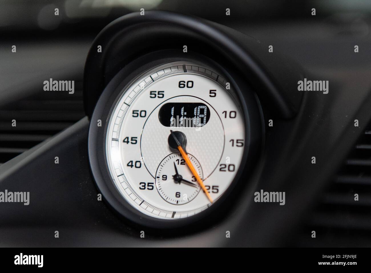 Dashboard guage gives an accurate readout of minutes and hours in analog or digital clock face. Stock Photo