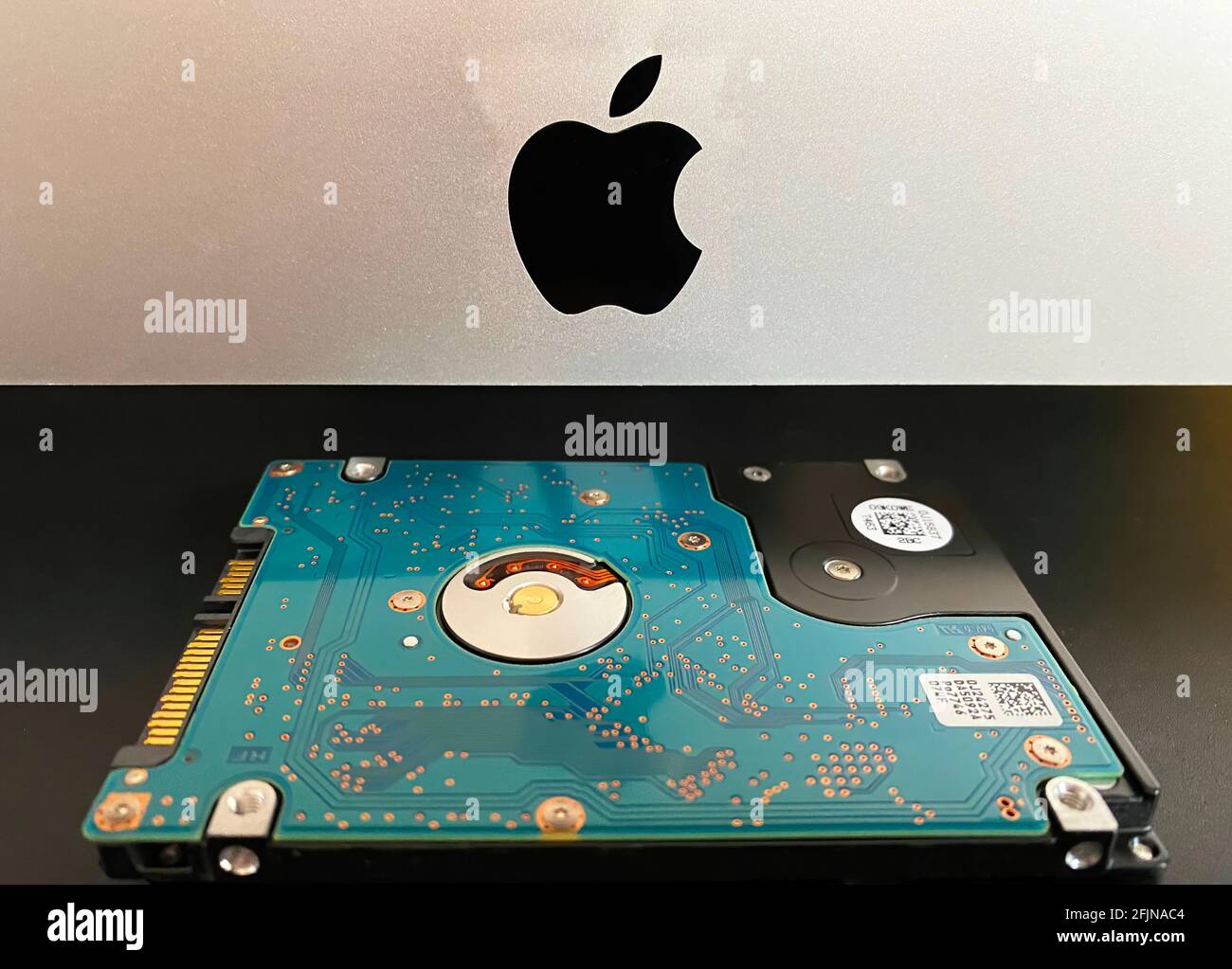 Mac 21,5 inch personal computer made by Apple Computers and MX500 5.5 inch solid state drive Stock Photo