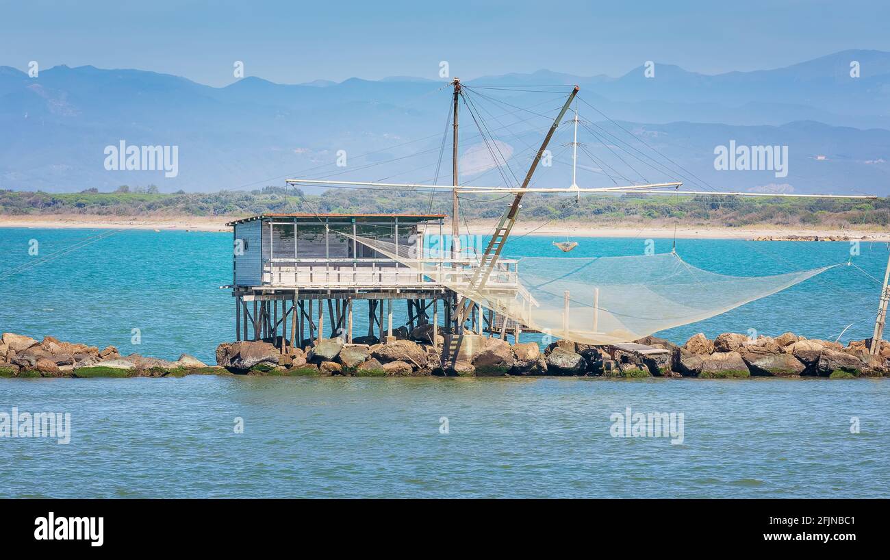 Typical fishing nets and fisher house with over the sea in Marina di Pisa, Tuscany, Italy Stock Photo