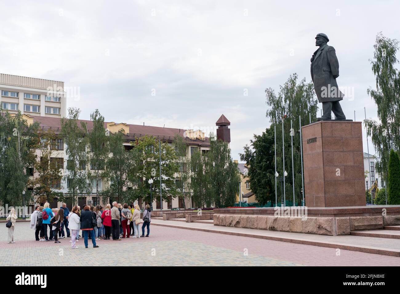 Grodno, Belarus - September 2, 2017: Group of lithuanian tourists standing near statue of Lenin in Grodno city center. Stock Photo