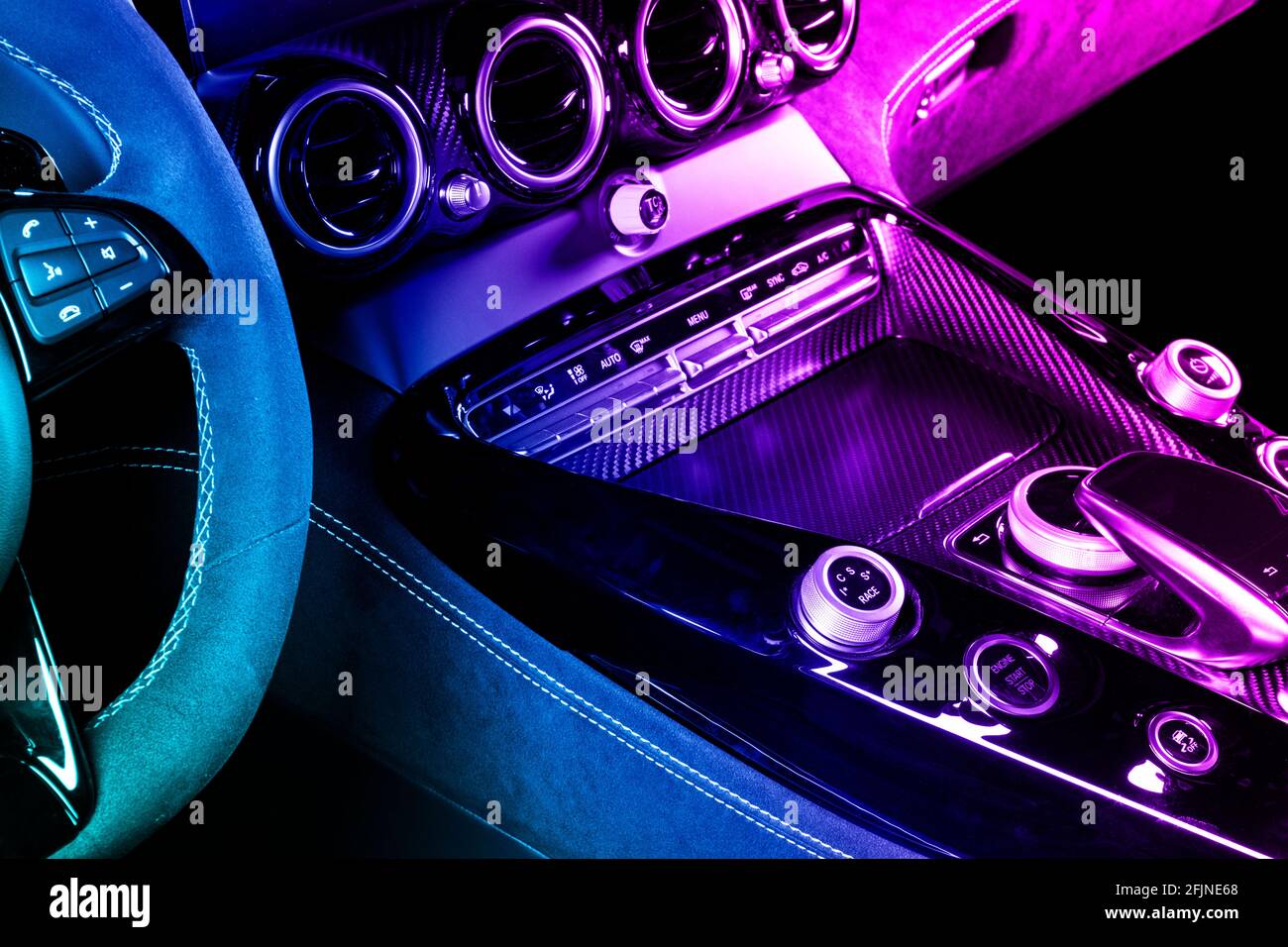 Modern luxury car inside in blue and pink tones. Interior of prestige  modern car with carbon panels. Comfortable leather seats. Steering wheel  and das Stock Photo - Alamy