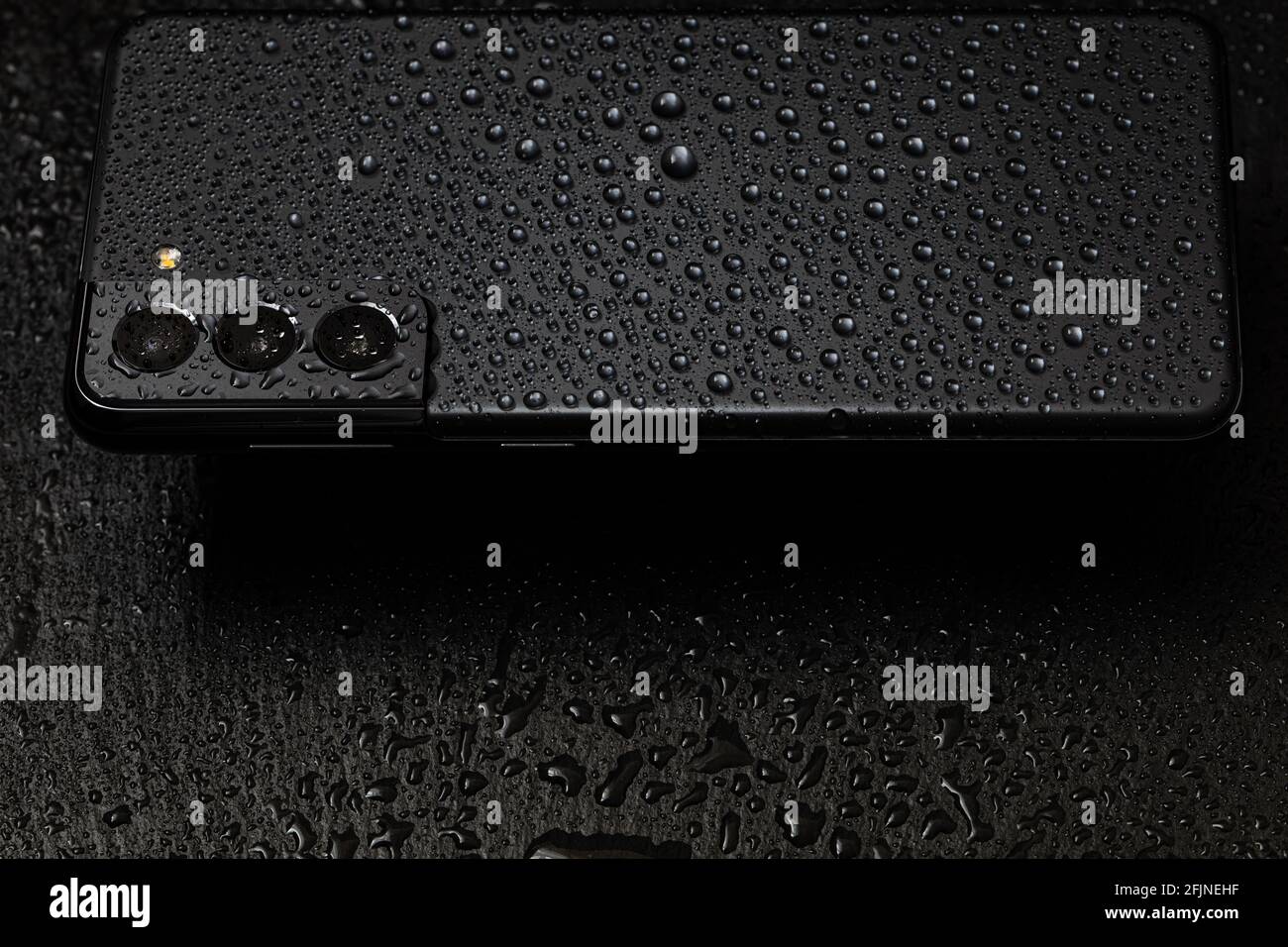 Seoul, South Korea - April 24, 2021: Samsung Galaxy S21 Phantom Grey in waterdrops Stock Photo