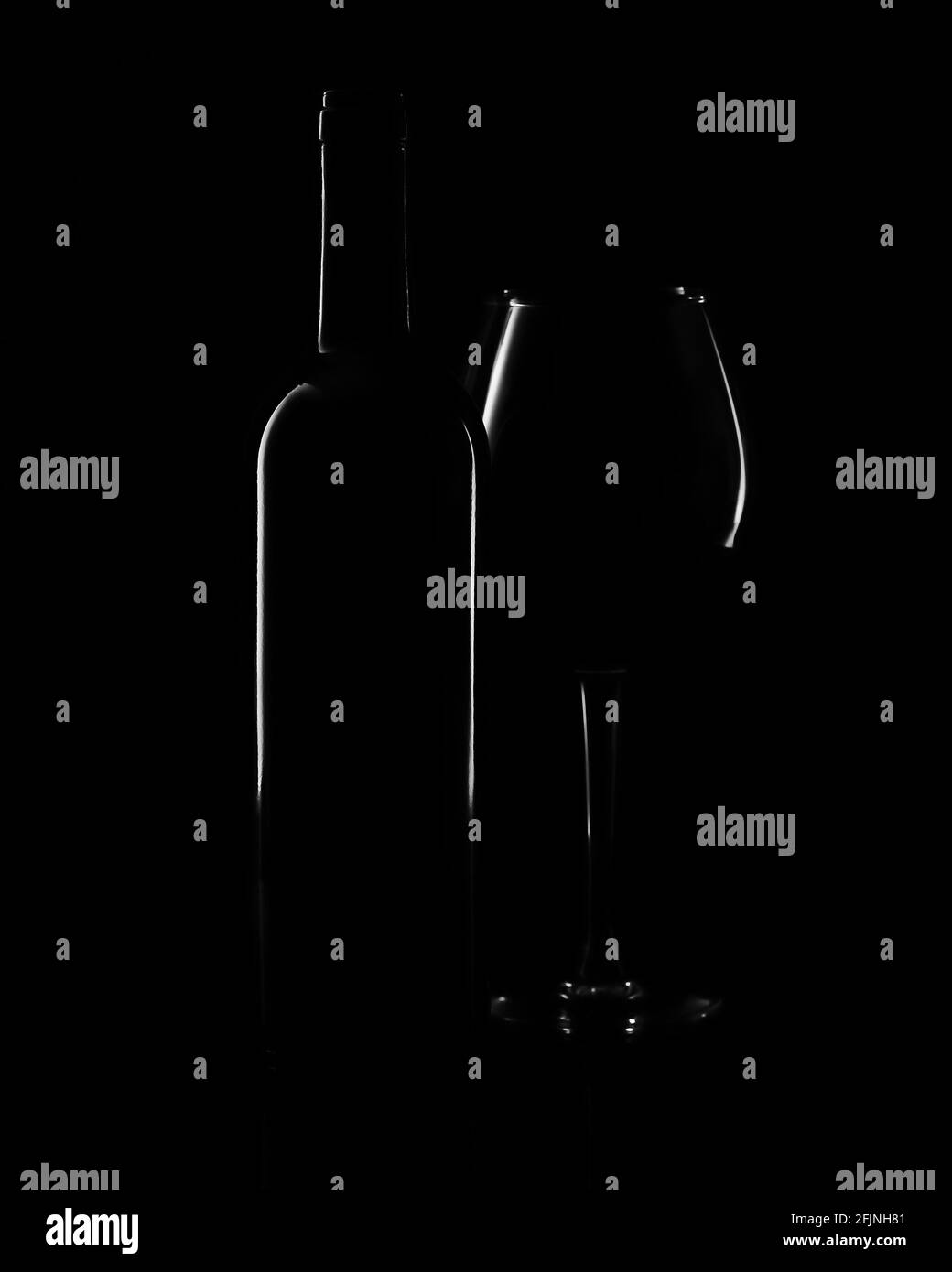 Bottle and wine glass on a black background. Minimalist concept Stock ...