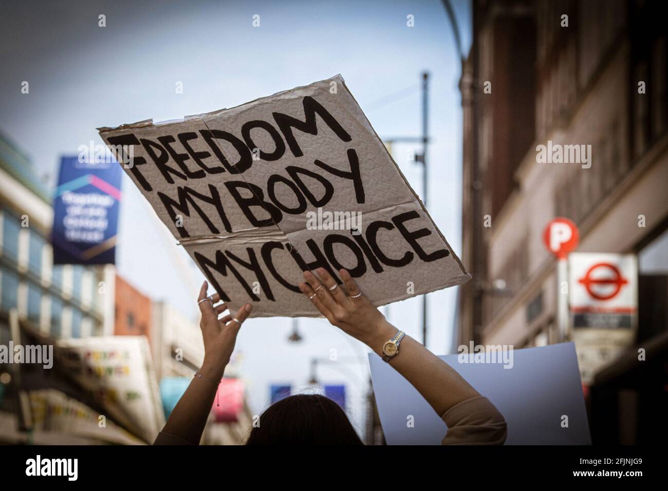 April 24, 2021, London, England, United Kingdom:  A woman holds a sign “Freedom My Body My Choice.” during an anti-lockdown protest. Stock Photo