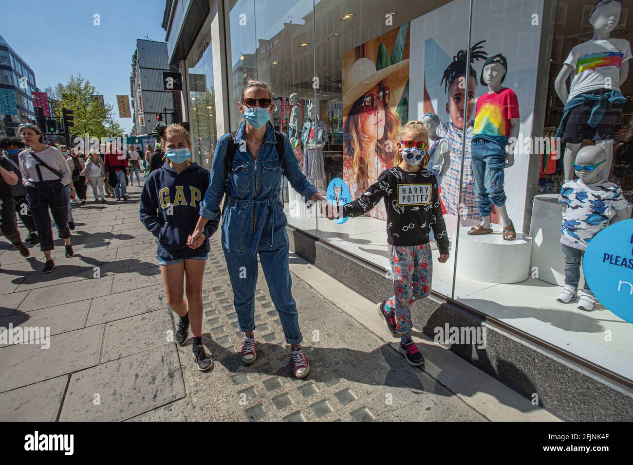 Family with kids in face mask  shopping  in oxford street ,London , UK Stock Photo