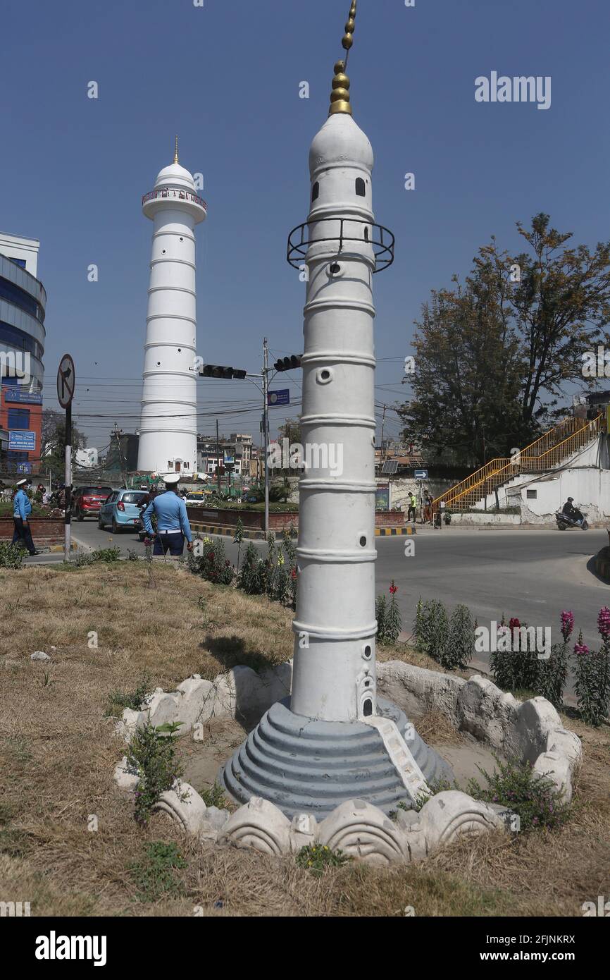 Kathmandu, Bagmati, Nepal. 25th Apr, 2021. The newly rebuilt Dharahara tower is pictured behind a replica of old Dharahara tower in a nearby park. The old tower, built in 1832, collapsed during a massive earthquake in 2015. Nepal on Sunday marked the sixth anniversary of a devastating earthquake that killed almost 9,000 people and left millions homeless. Credit: Sunil Sharma/ZUMA Wire/Alamy Live News Stock Photo