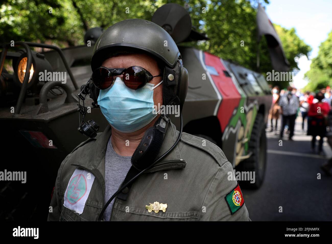 Lisbon, Portugal. 25th Apr, 2021. A man wearing a face mask and a military suit takes part in a