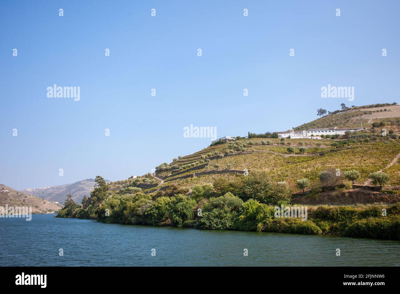 River cruise along the Douro River as it flows through the beautiful Portuguese countryside of the Douro Valley in northern Portugal. Stock Photo