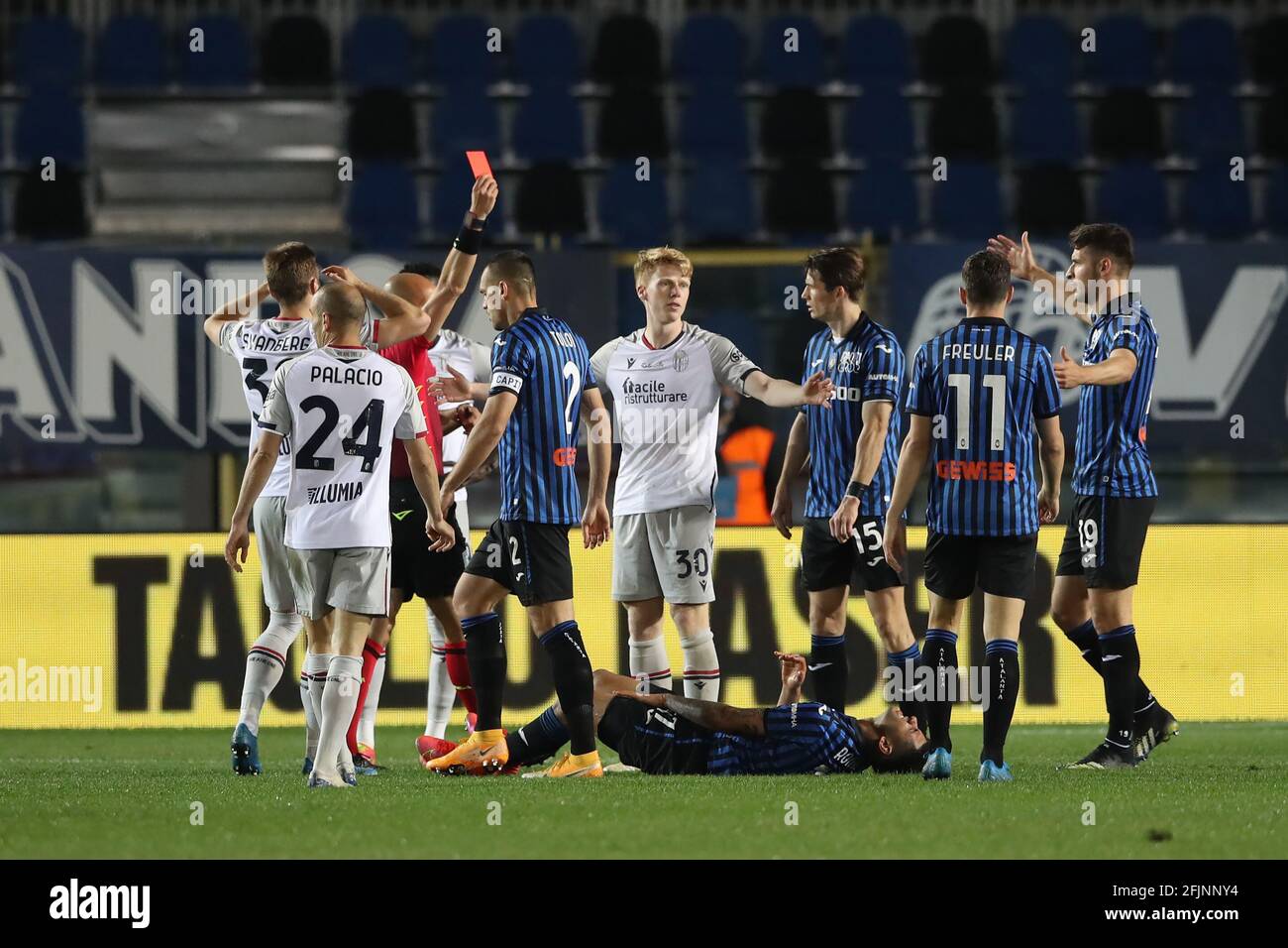 Bergamo, Italy, 25th April 2021. Jerdy Schouten of Bologna FC is shown a red card by referee Michael Fabbri for a bad challenge on Cristian Romero of Atalanta during the Serie A match at Gewiss Stadium, Bergamo. Picture credit should read: Jonathan Moscrop / Sportimage Stock Photo
