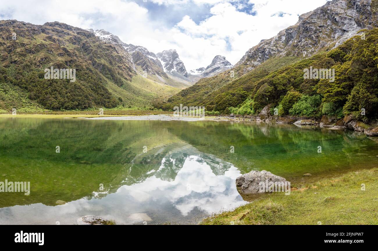 Tranquil mountain lake Mackenzie at the famous Routeburn Track, Fiordland National Park, South Island of New Zealand Stock Photo