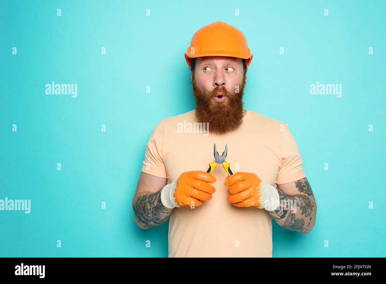 Incompetent worker is unsure about his work. cyan background Stock Photo