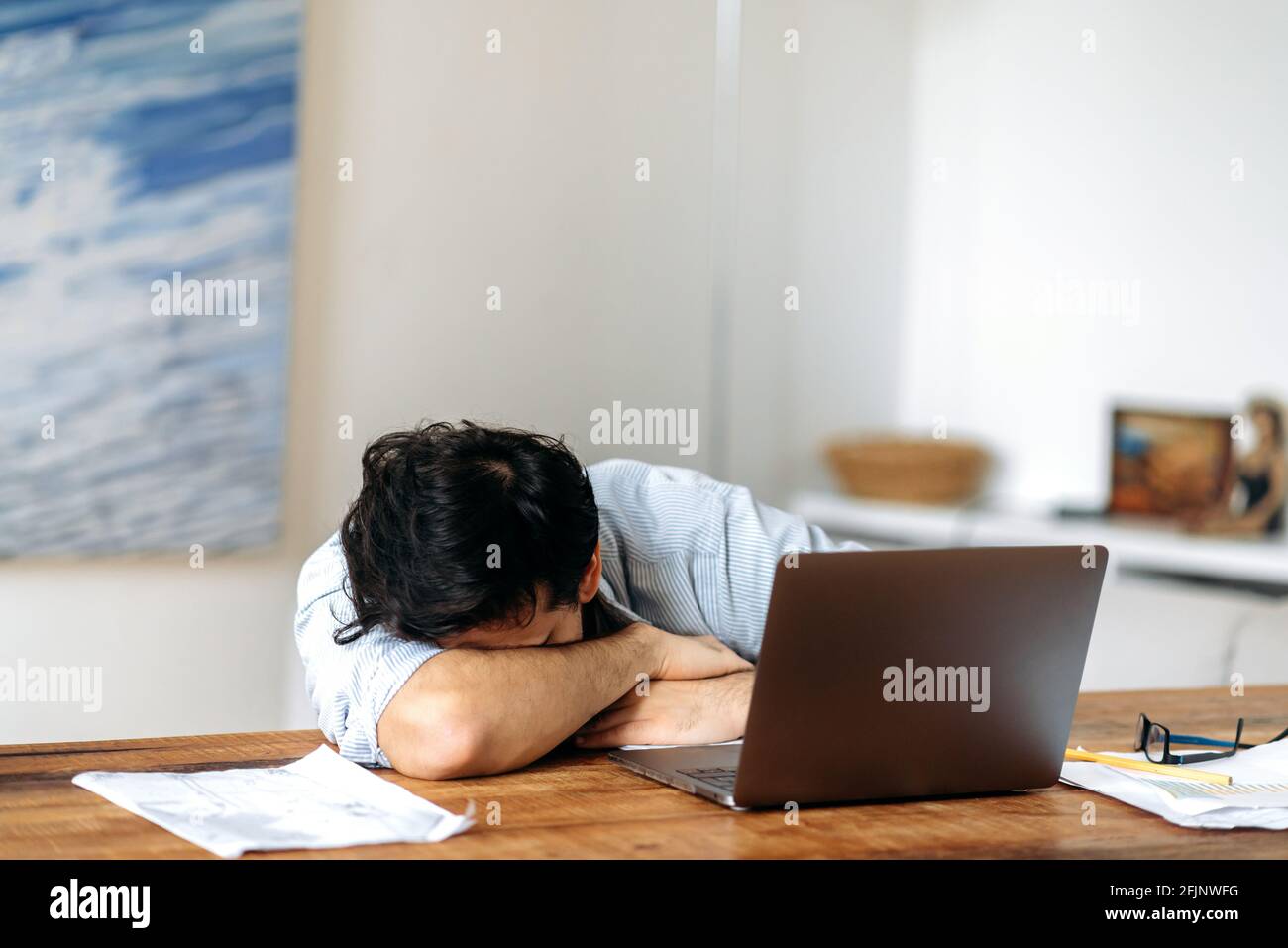 Tired hispanic guy, manager, freelancer or student working or studying