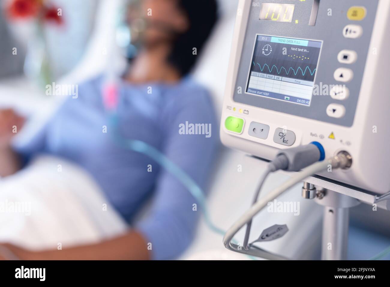 Ventilator monitor and african american female patient in hospital