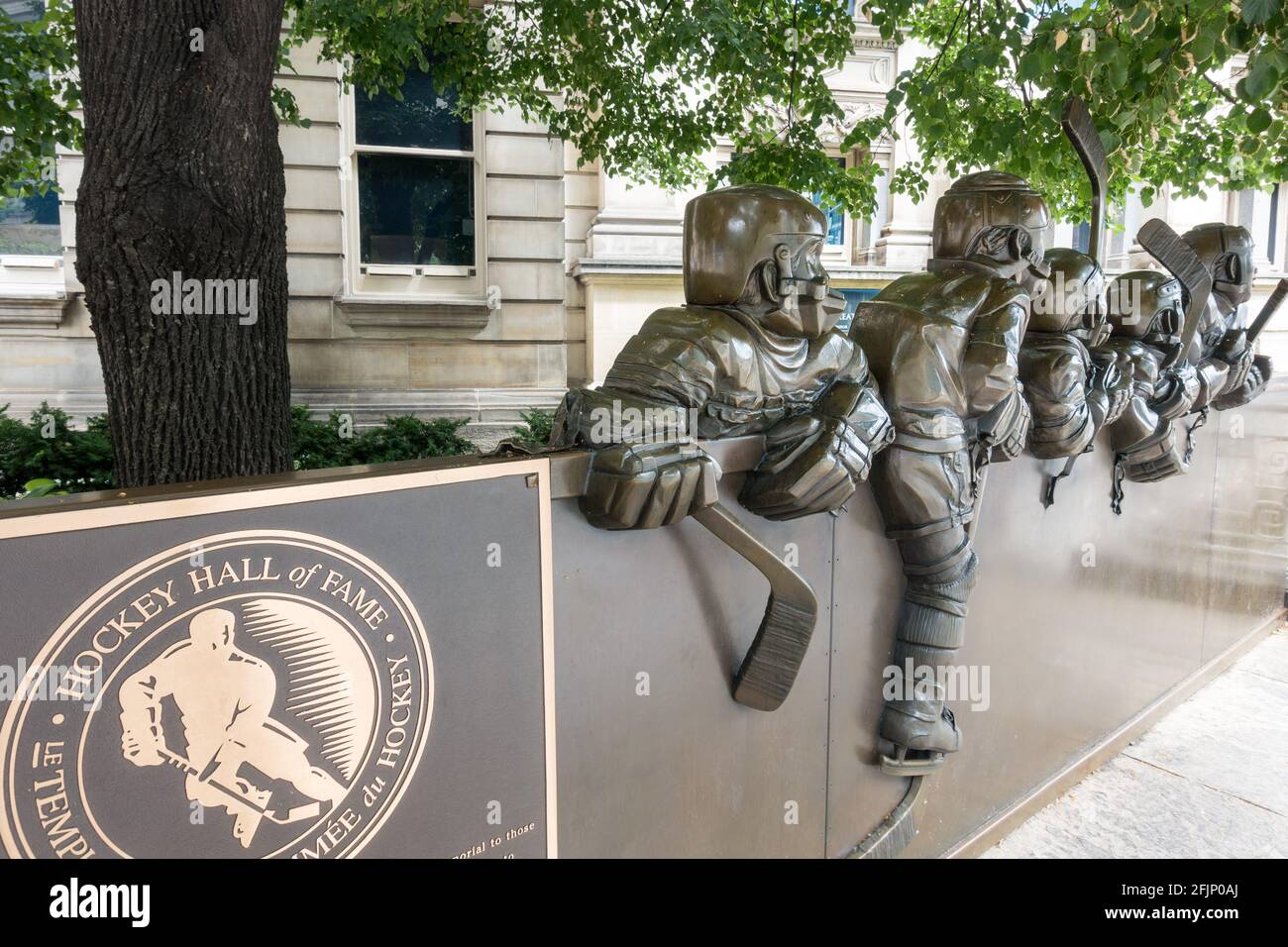 An outdoor sculpture by artist, Edie Parker called 'Our Game' of young hockey players at the boards ready for action at Toronto's Hockey Hall of Fame Stock Photo