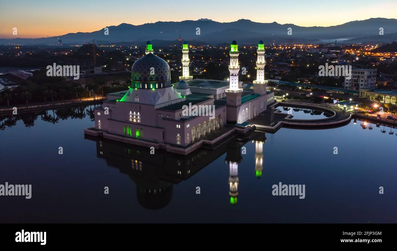 Aerial Drone image of beautiful mosque and the most famous tourist spot Likas Mosque(Masjid Bandaraya Likas), Kota Kinabalu, Sabah, Malaysia. during T Stock Photo