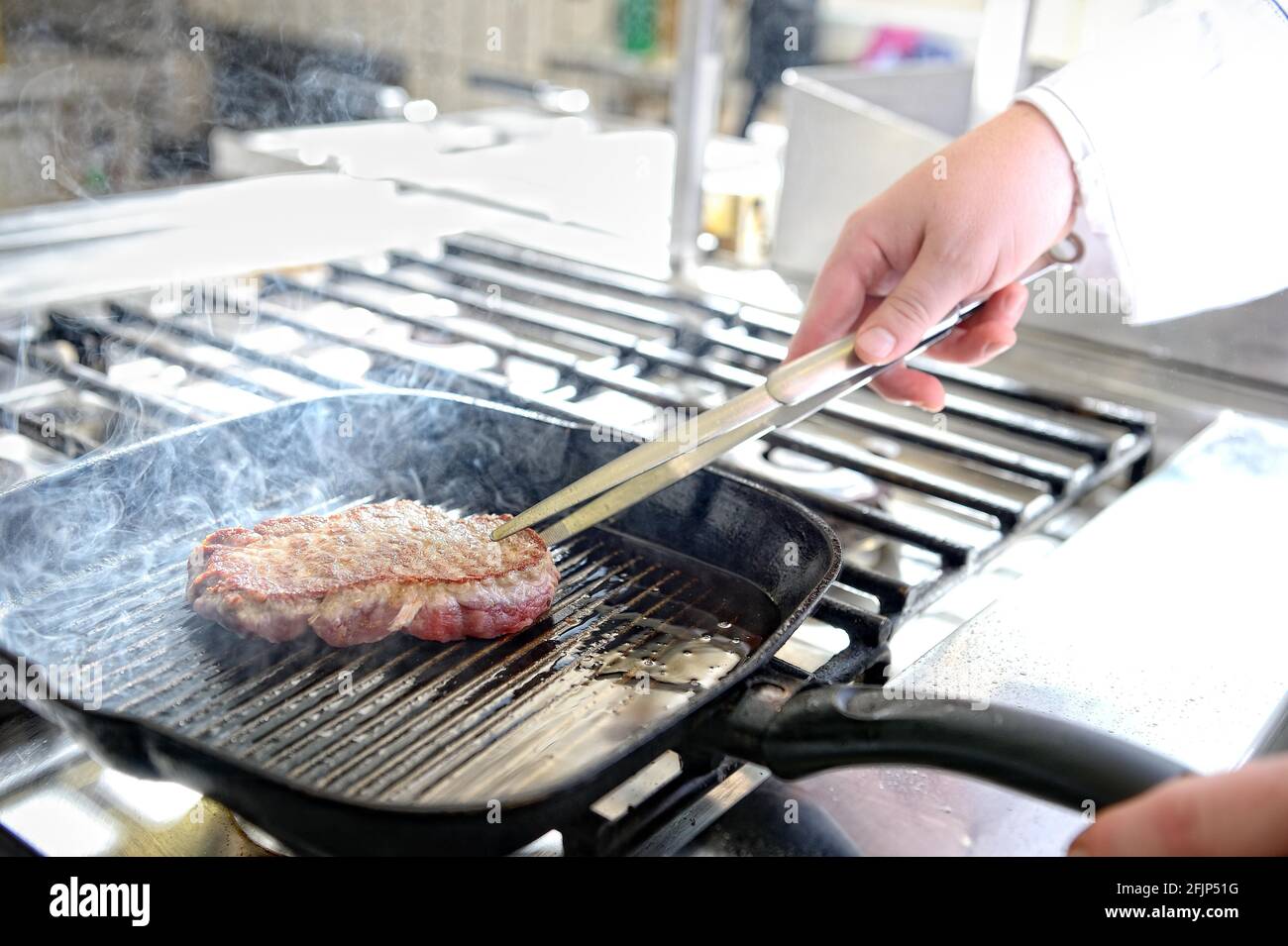 Steak in a grill pan while frying, Germany Stock Photo Alamy