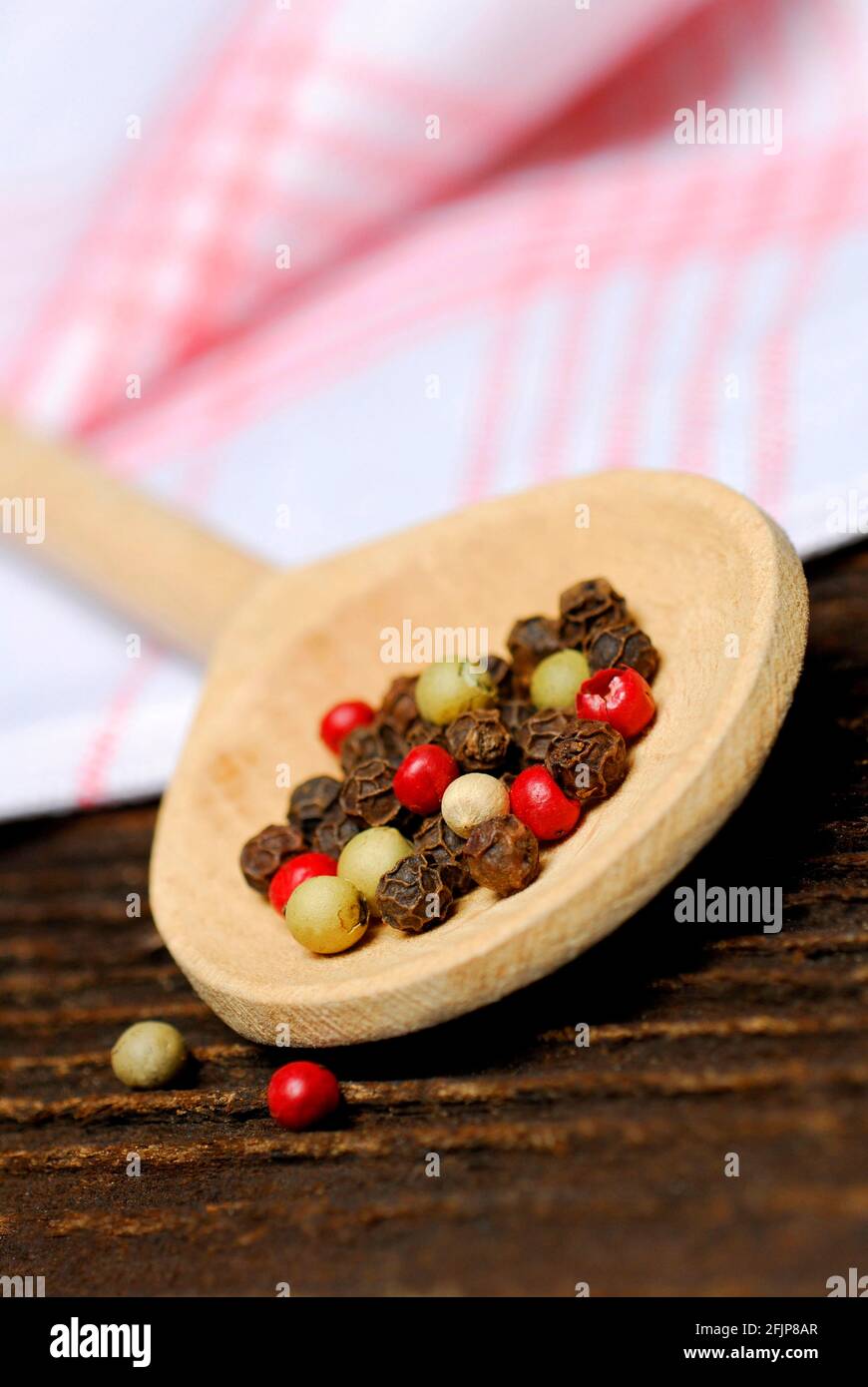 Peppercorns on wooden spoon, black, green, white and pink pepper () , peppercorns Stock Photo