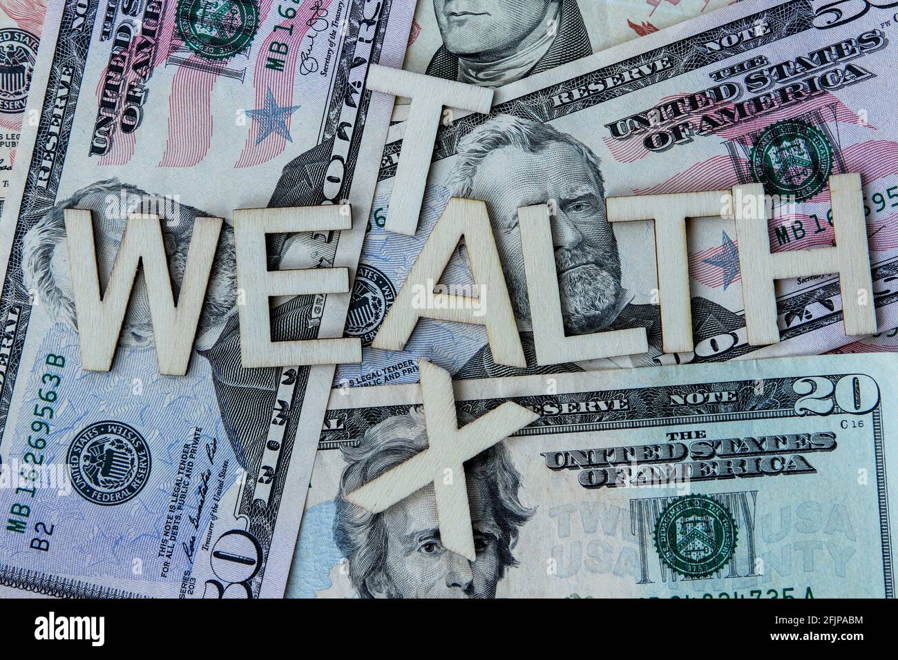 Wealthy tax signage on a background of American dollars. Stock Photo