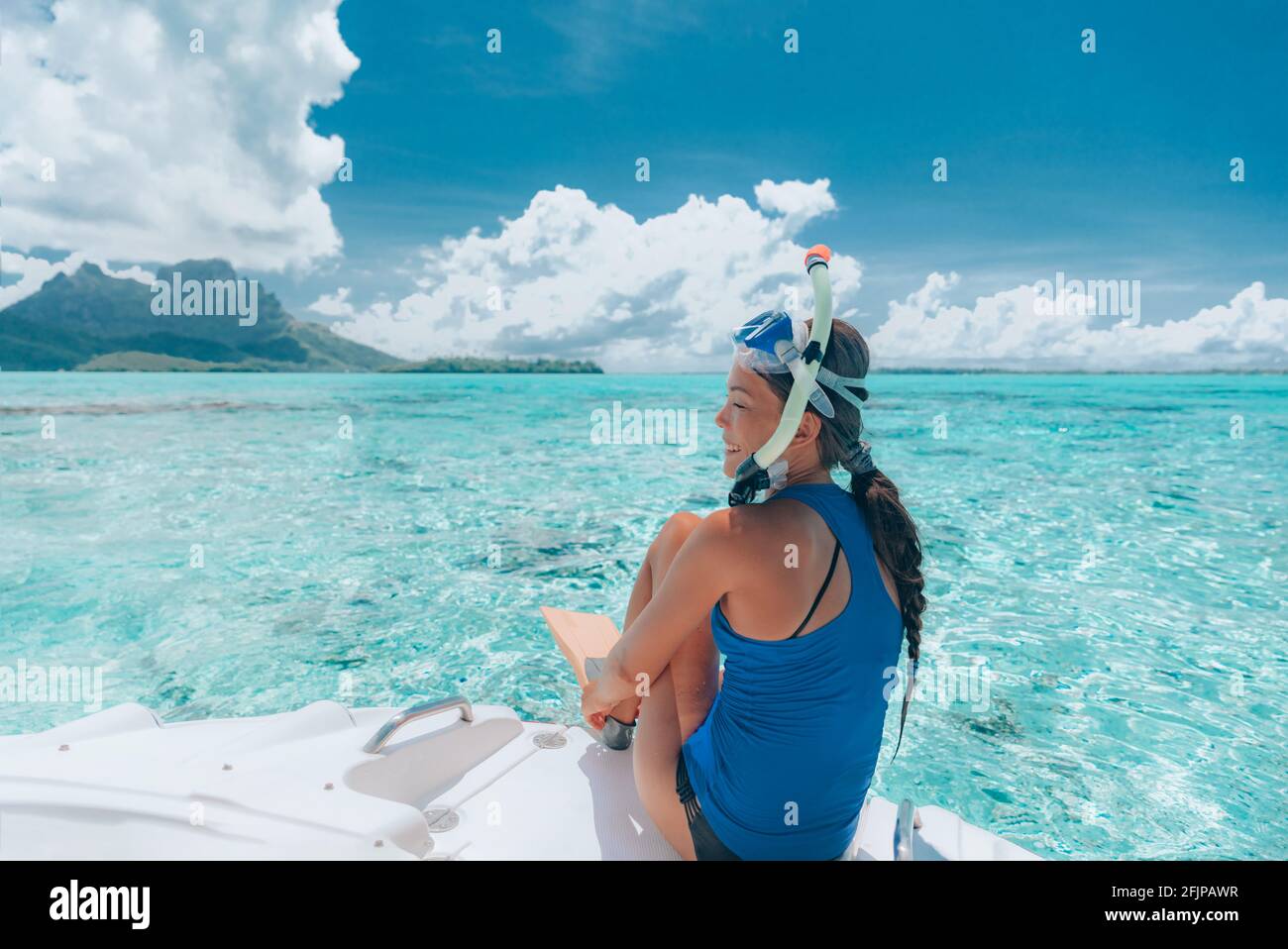 Snorkeling from boat in Bora Bora, Tahiti, French Polynesia. Woman