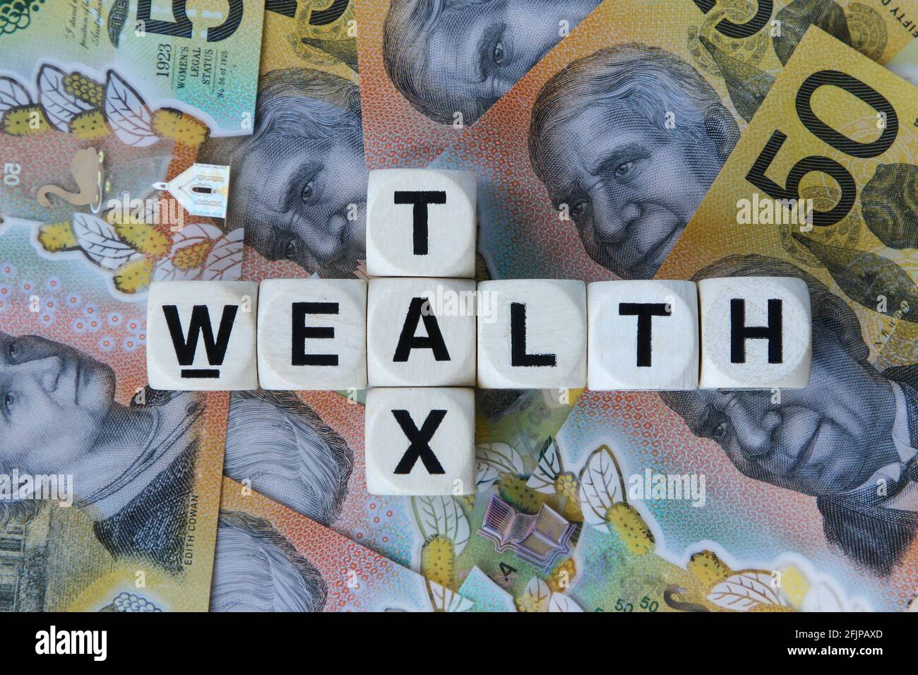 Wealth tax signage on a background of Australian dollars. Stock Photo