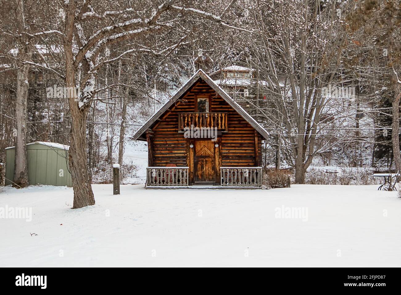 A garden shed built to look like a log cabin - winter snow scene Stock Photo