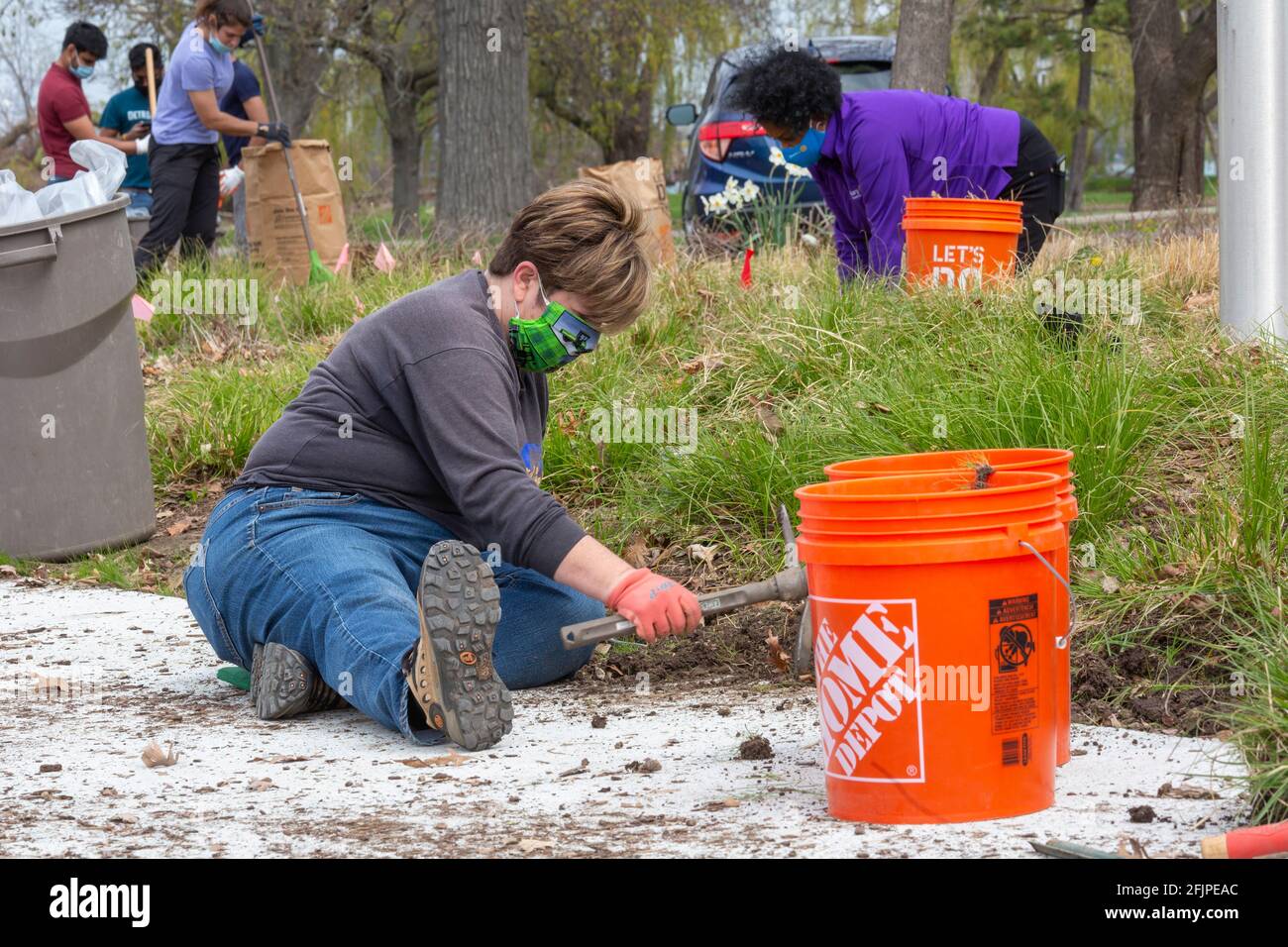Detroit, Michigan - During Earth Week, volunteers clean up Rotary Park, a garden of native plants in Belle Isle State Park. The park is a project of m Stock Photo