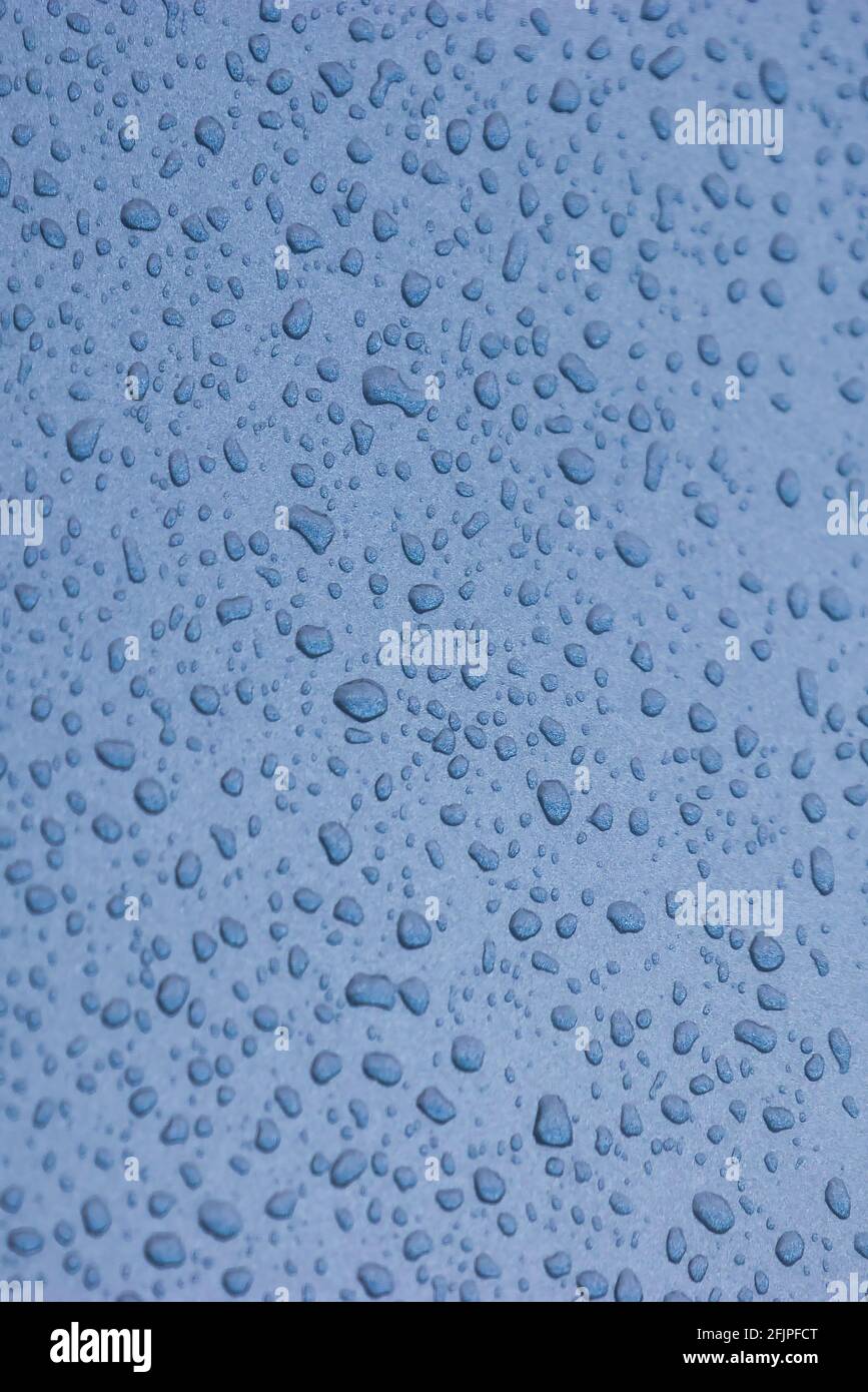 Blue abstract sky and raindrops on glass window Stock Photo