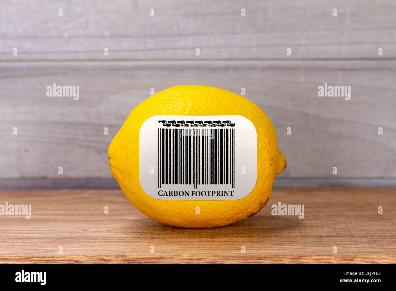 Carbon Footprint barcode label on lemon, environmental impact sustainability label on food Stock Photo
