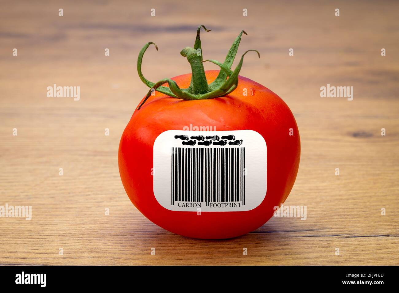 Carbon Footprint barcode label on Tomato, environmental impact sustainability label on food Stock Photo
