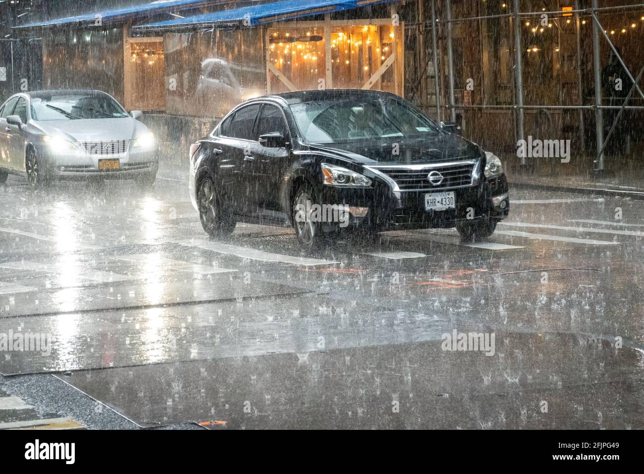 Traffic in Midtown Manhattan During a Violet Spring Rainstorm, NYC, USA Stock Photo