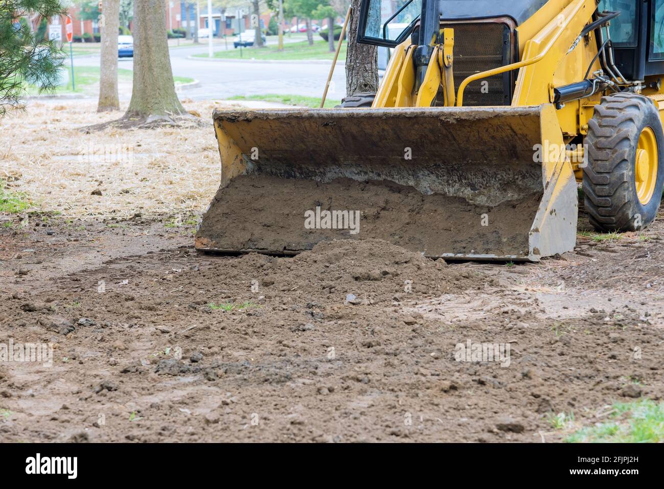 Bulldozer moving, leveling ground at construction site Stock Photo