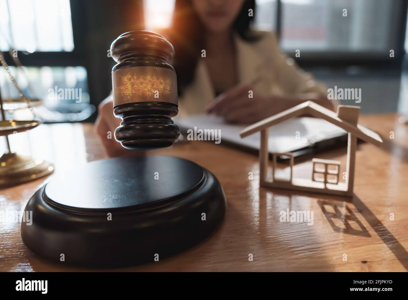 Business woman and lawyers discussing contract papers with brass scale on wooden desk in office. Law, legal services, advice, Justice and real estate Stock Photo