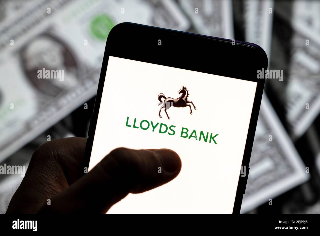 China. 23rd Apr, 2021. In this photo illustration, a Lloyds Bank plc logo seen displayed on a smartphone with USD (United States dollar) currency in the background. (Photo by Budrul Chukrut/SOPA Images/Sipa USA) Credit: Sipa USA/Alamy Live News Stock Photo