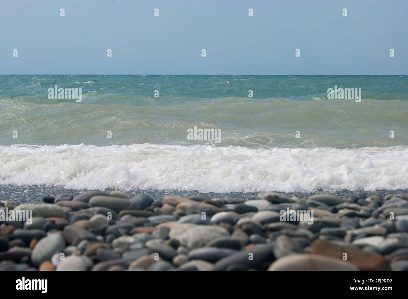The Sea Wave of the Black Sea is a pebble beach. Smooth horizon, blue sky. Vacation vacation vacation summer happiness appeasement Stock Photo