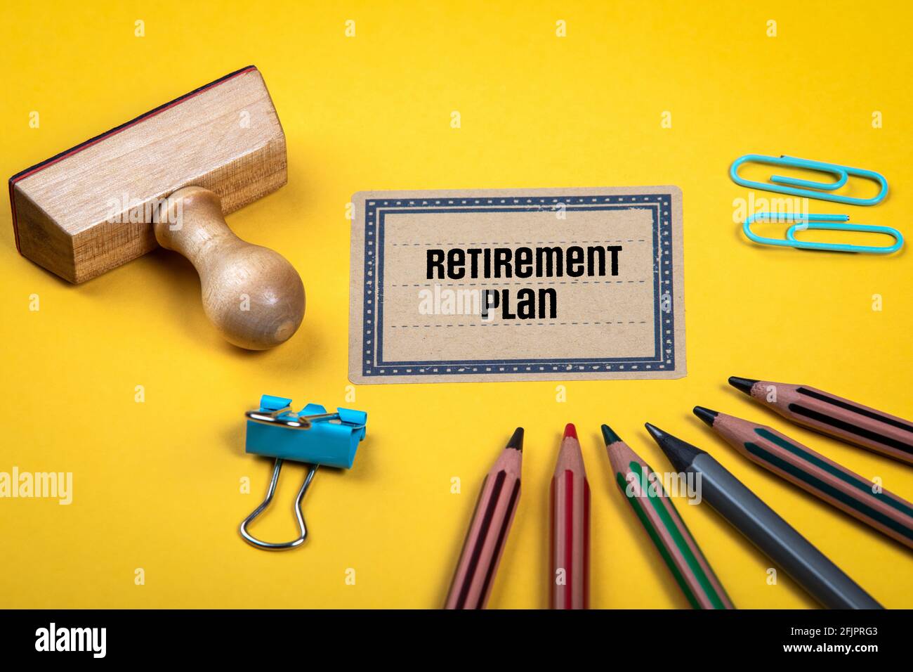 Retirement Plan. Yellow document folder and office supplies. Stock Photo