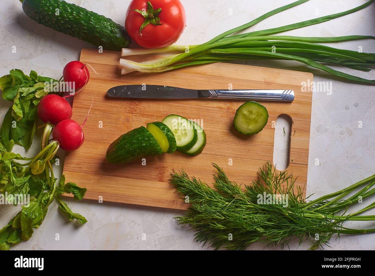 cucumber sliced on a cutting board and vegetables Stock Photo - Alamy