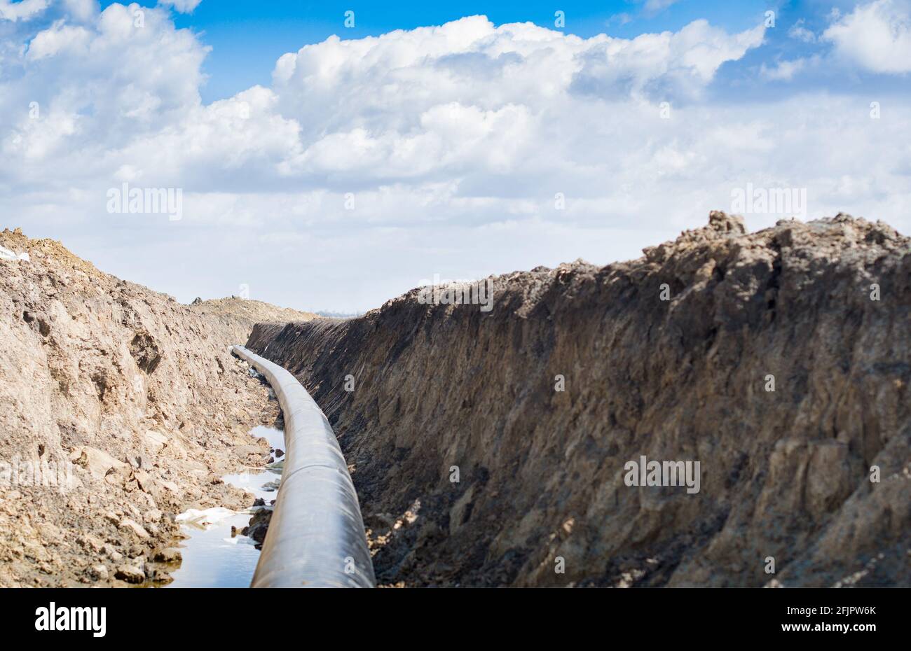 Natural gas pipeline construction work. A dug trench in the ground for