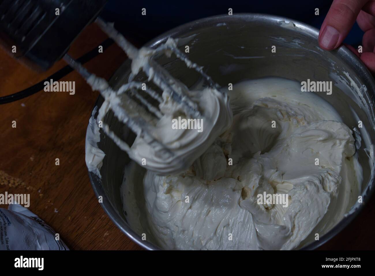 an electric mixer with whipped cream coating the beaters Stock Photo Alamy