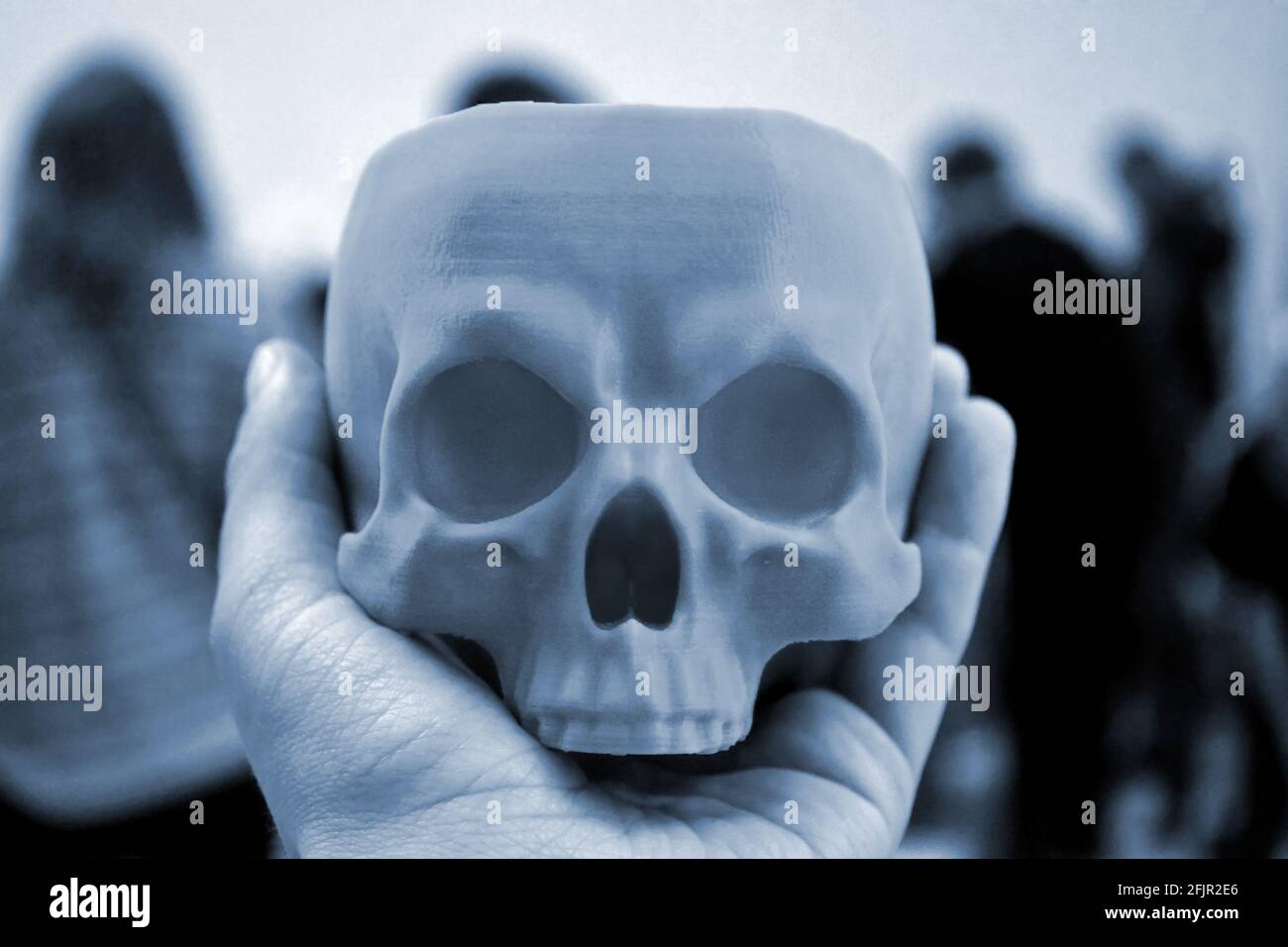 Skull printed on 3d printer in man's hand. Progressive modern Stock Photo