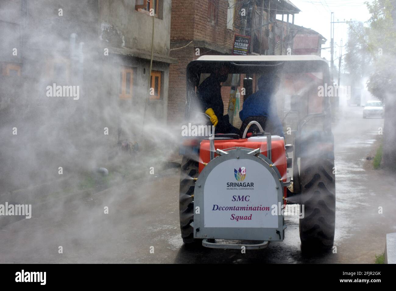 Srinagar, Jammu and kashmir India 07 August 2020. Fumigation of streets and houses by Kit wearing men warriors sanitizing and also parts of srinagar c Stock Photo