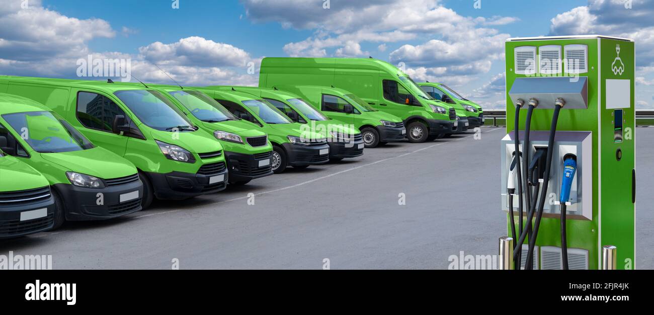 Electric vehicles charging station on a background of a row of vans. Green transportation concept Stock Photo