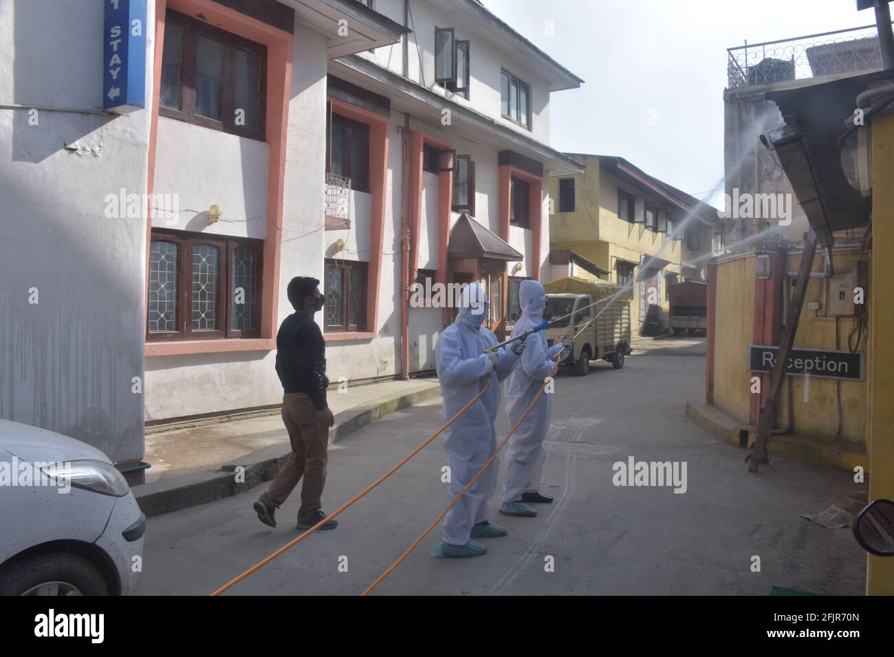 Srinagar, Jammu and kashmir India 07 August 2020. Vehicles small and big sanitizing towns and streets during coronavirus lockdown. Men dressed kits ar Stock Photo