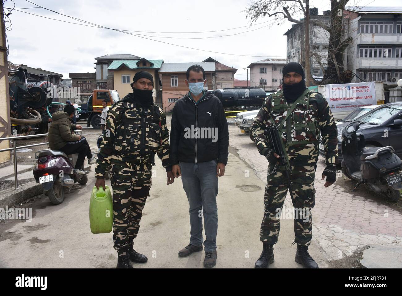 Srinagar, Jammu and kashmir India 07 August 2020. Vehicles small and big sanitizing towns and streets during coronavirus lockdown. Men dressed kits ar Stock Photo