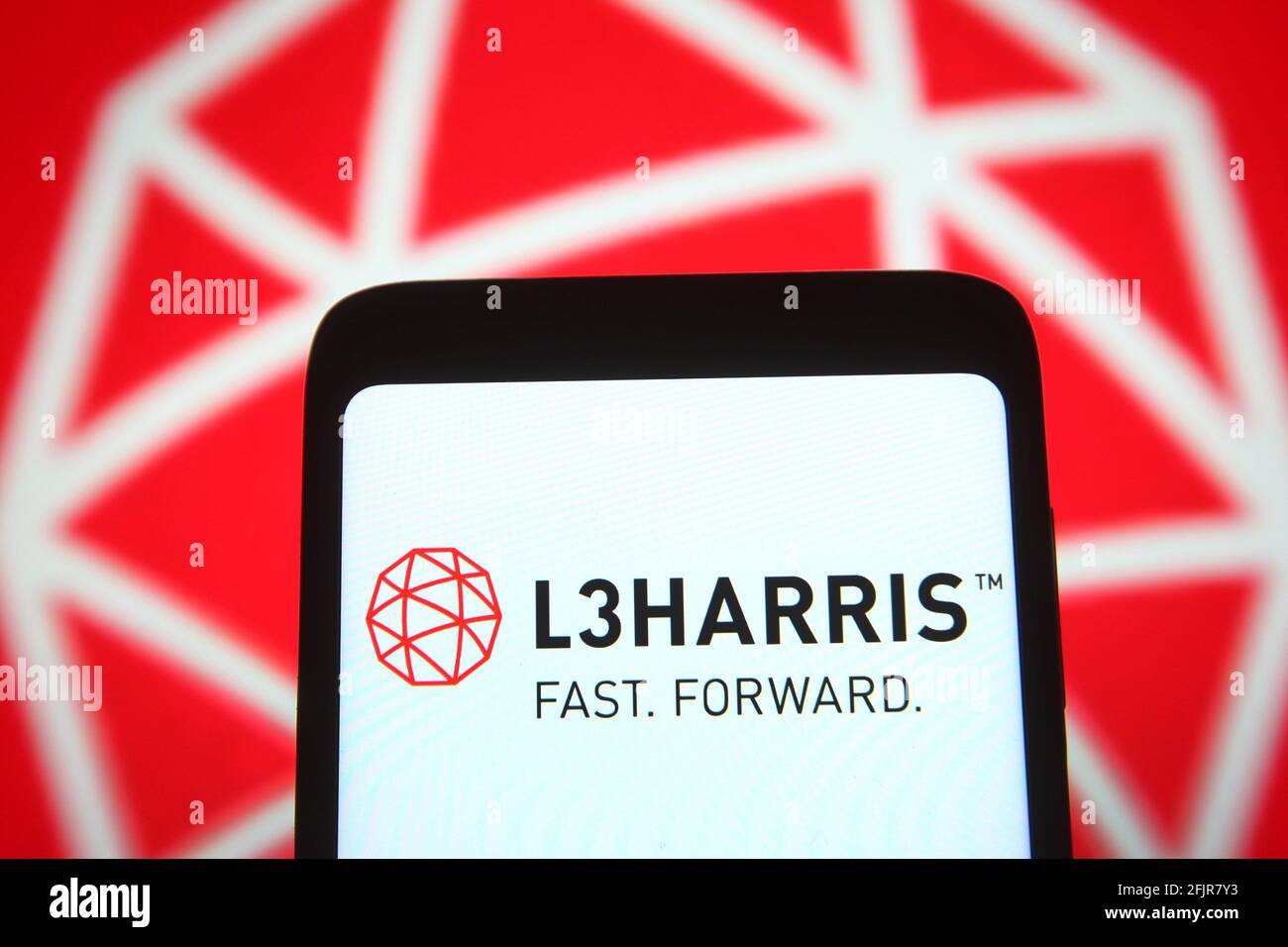 In this photo illustration, the L3Harris logo is seen on a smartphone