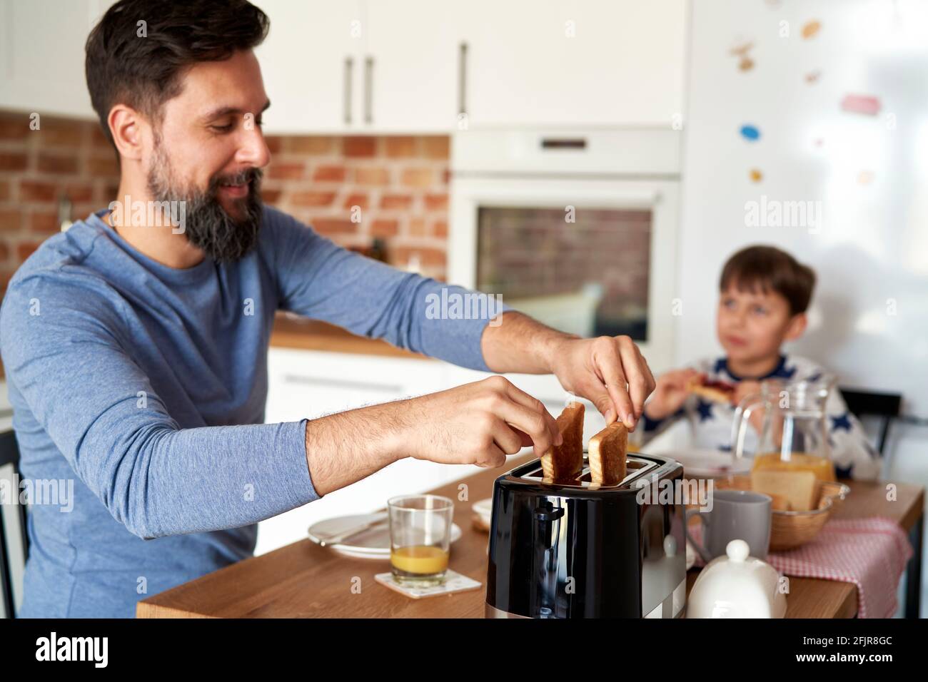 Father and son having breakfast together Stock Photo
