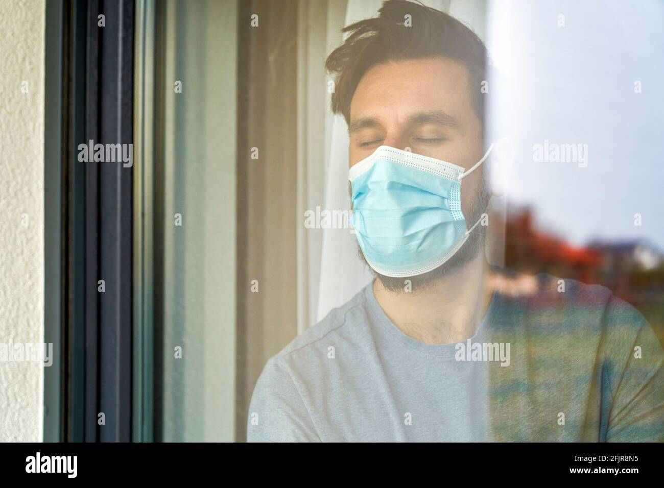 Close up of man with closed eyes thirsty for sunlight Stock Photo