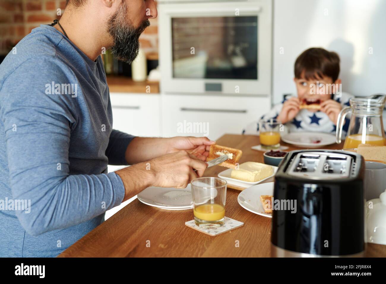 Close up of father and son having breakfast together Stock Photo