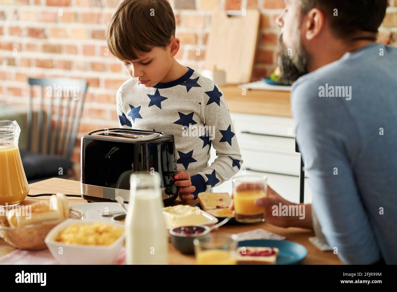 Father and son during breakfast in the morning Stock Photo