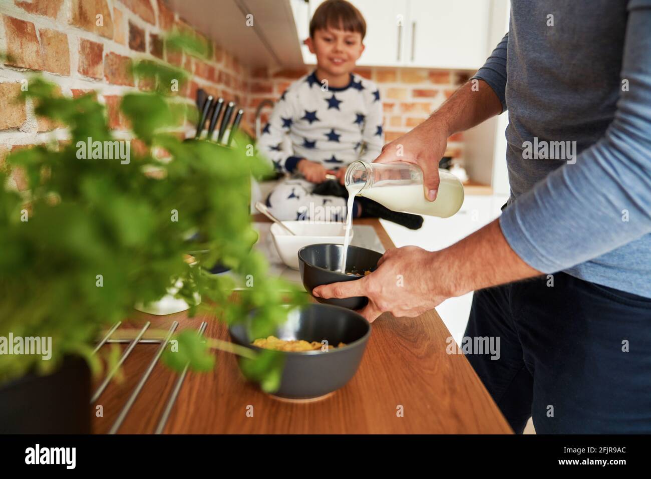 Close up of father preparing breakfast cereal Stock Photo