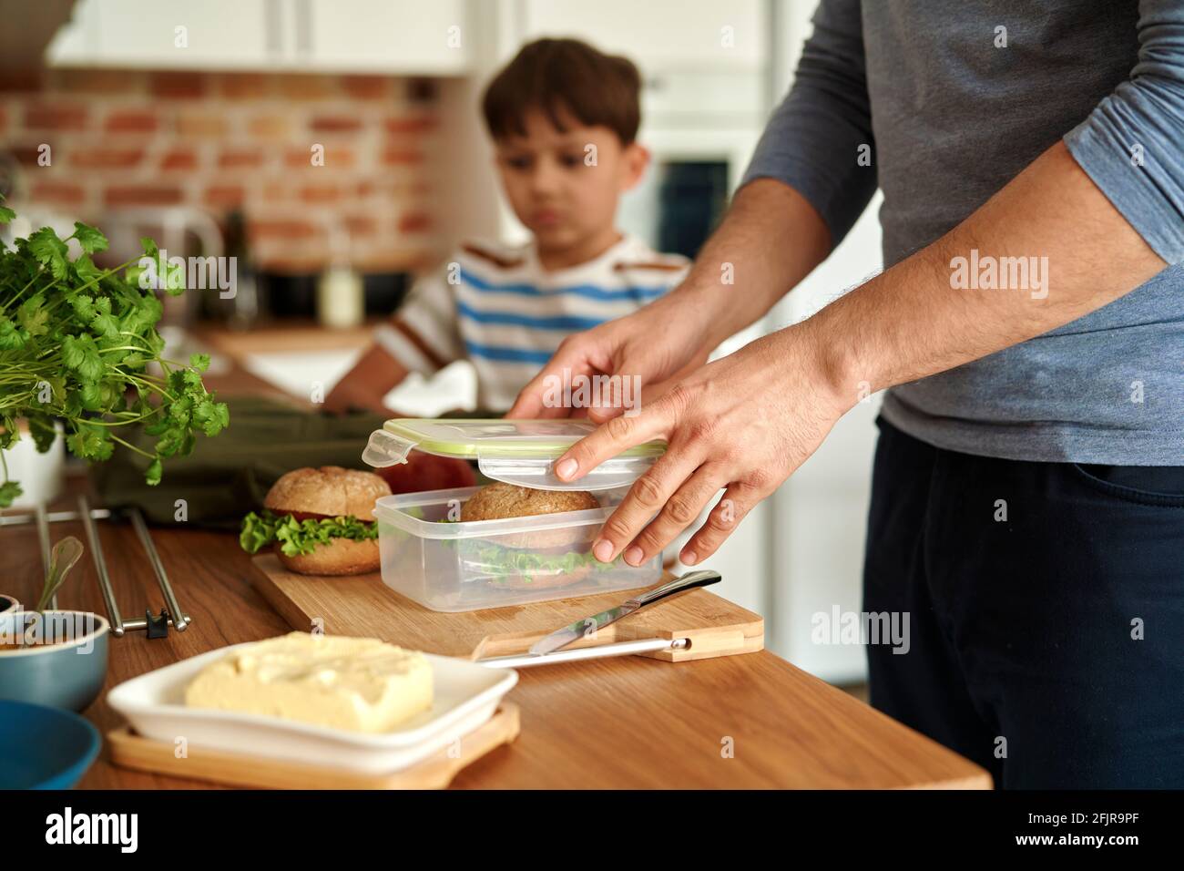 Close up of father making lunch box for son Stock Photo